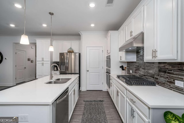 kitchen with sink, stainless steel appliances, pendant lighting, a kitchen island with sink, and white cabinets