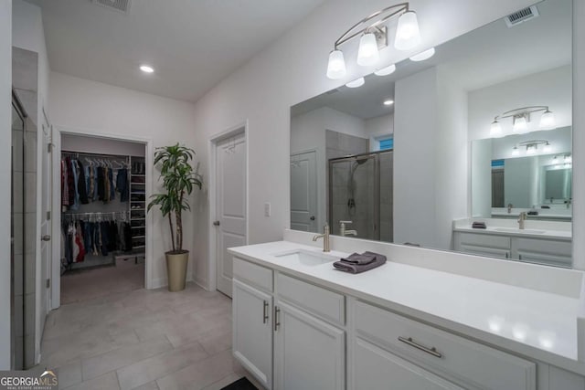 bathroom featuring vanity and a shower with door