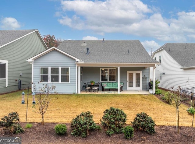 back of house featuring outdoor lounge area, a yard, a patio, and french doors