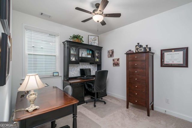 office space with light carpet and ceiling fan