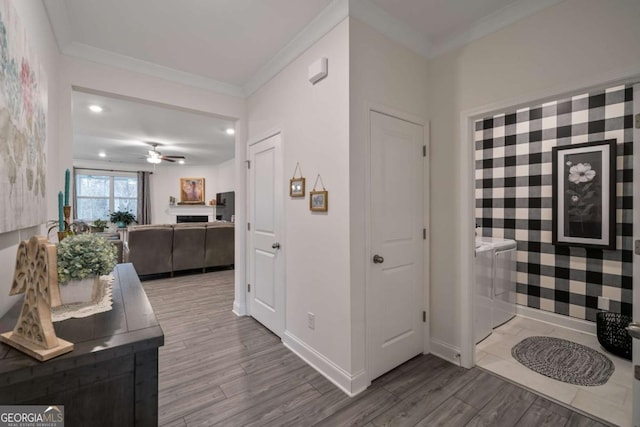 bathroom with crown molding, hardwood / wood-style floors, and ceiling fan