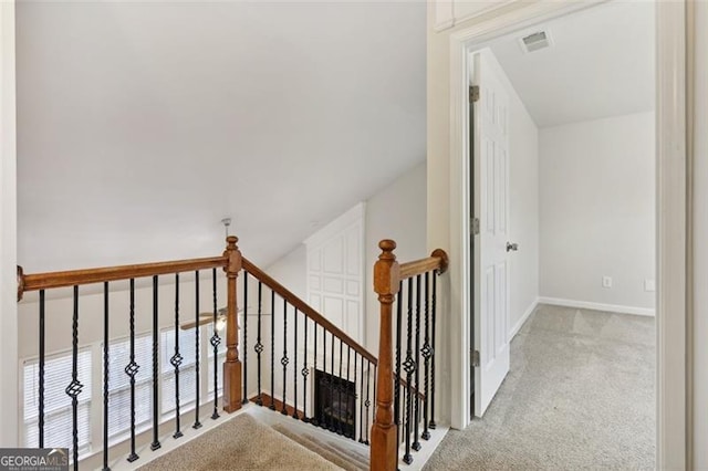 staircase featuring carpet and lofted ceiling