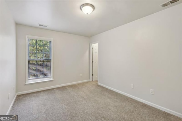 unfurnished room with light carpet