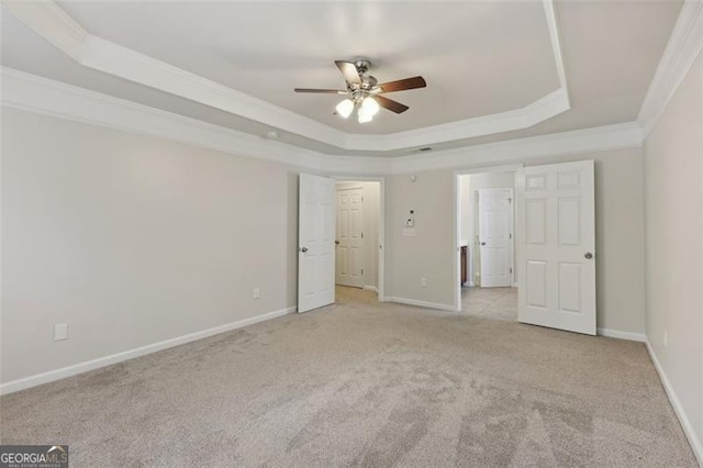 unfurnished bedroom with light carpet, a raised ceiling, ceiling fan, and ornamental molding