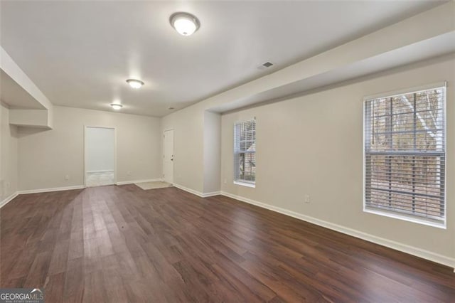 spare room featuring dark hardwood / wood-style flooring