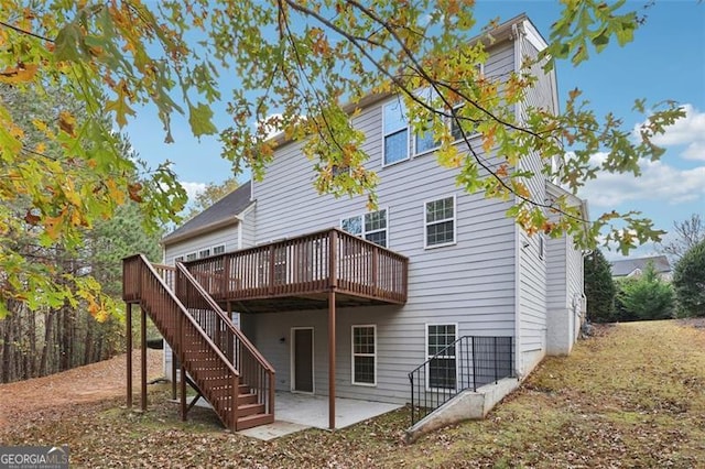 rear view of house featuring a patio area and a deck