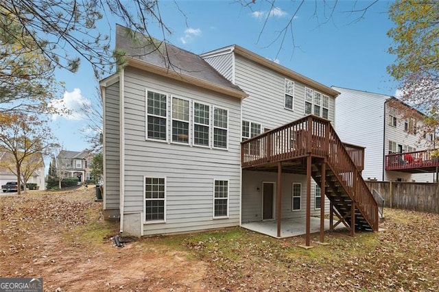 rear view of property featuring a patio area and a deck