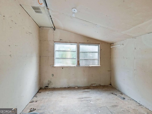 spare room featuring vaulted ceiling