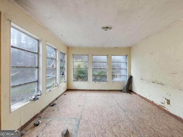 unfurnished sunroom featuring a wealth of natural light