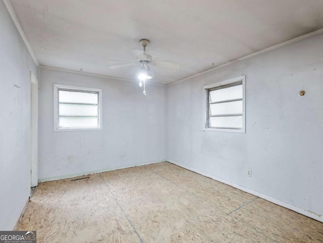 unfurnished room with ceiling fan and ornamental molding