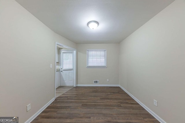 spare room with dark hardwood / wood-style flooring