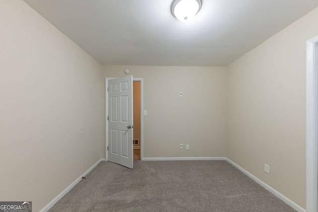 spare room with light colored carpet