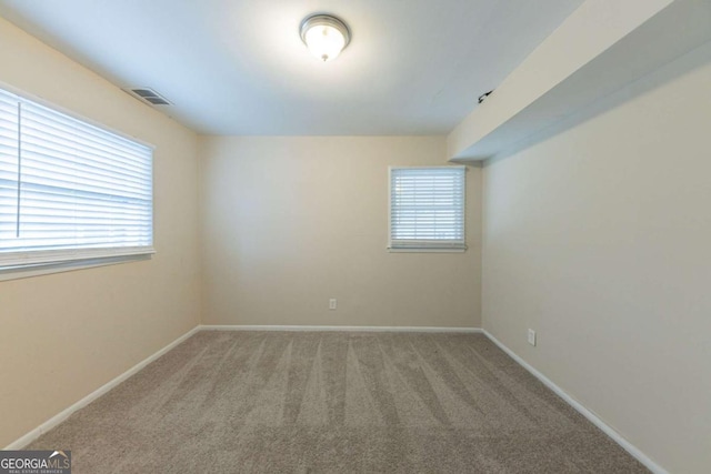 empty room featuring plenty of natural light and carpet floors