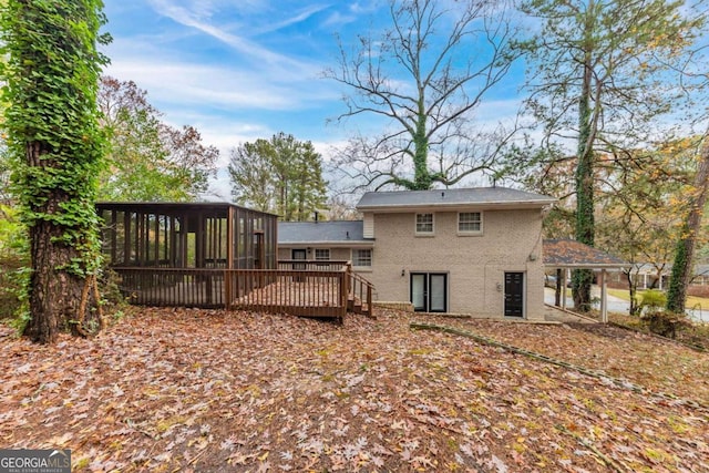 back of property with a wooden deck and a sunroom