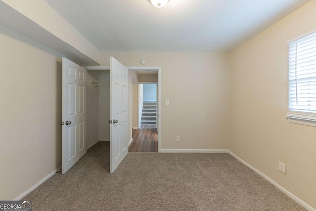 unfurnished bedroom with carpet and a closet