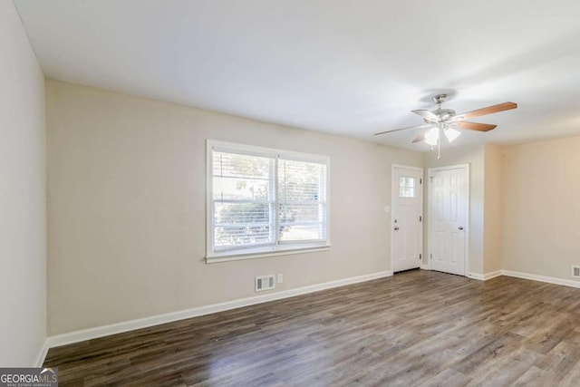 spare room with ceiling fan and dark hardwood / wood-style flooring