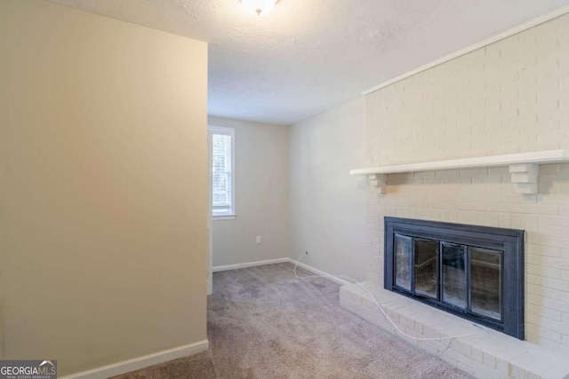 unfurnished living room featuring a textured ceiling, a fireplace, and light carpet