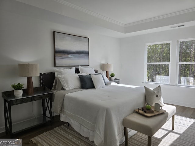 bedroom with crown molding and hardwood / wood-style floors