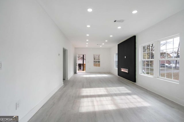 interior space featuring a fireplace and light hardwood / wood-style flooring