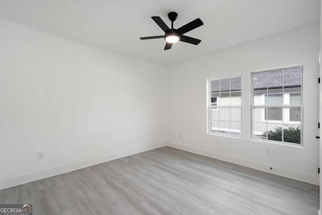 empty room with light hardwood / wood-style floors and ceiling fan