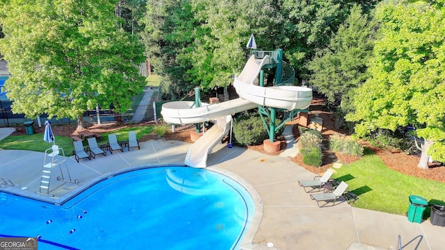 view of pool with a patio area and a water slide