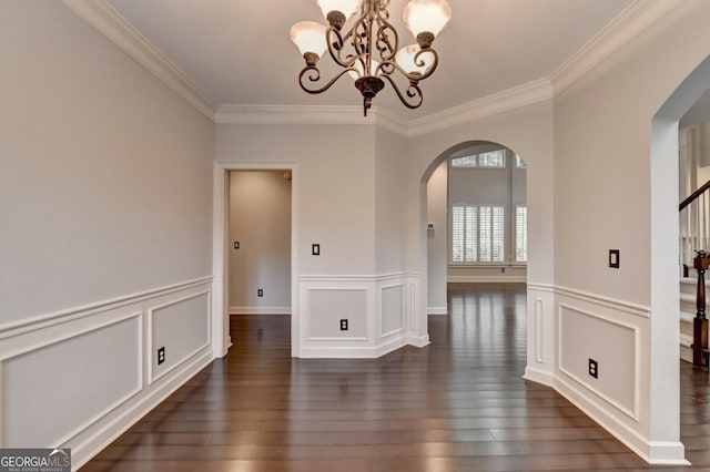 unfurnished dining area with ornamental molding, dark wood-type flooring, and a notable chandelier