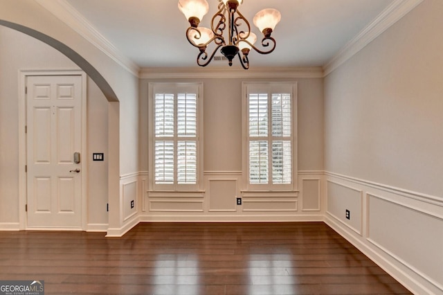 unfurnished dining area with ornamental molding, dark hardwood / wood-style floors, and a notable chandelier