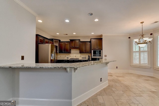 kitchen featuring kitchen peninsula, ornamental molding, appliances with stainless steel finishes, light stone counters, and dark brown cabinetry