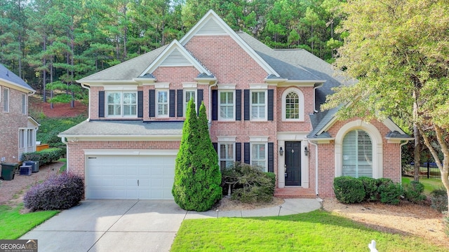 view of front of house featuring central AC and a garage