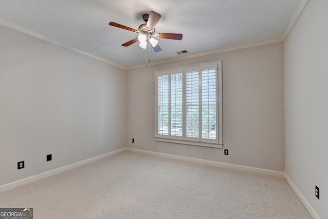 carpeted spare room featuring ceiling fan and crown molding