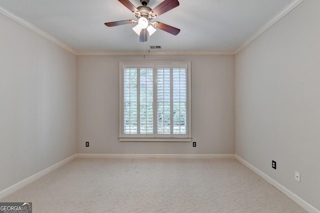 spare room with carpet, ceiling fan, and crown molding