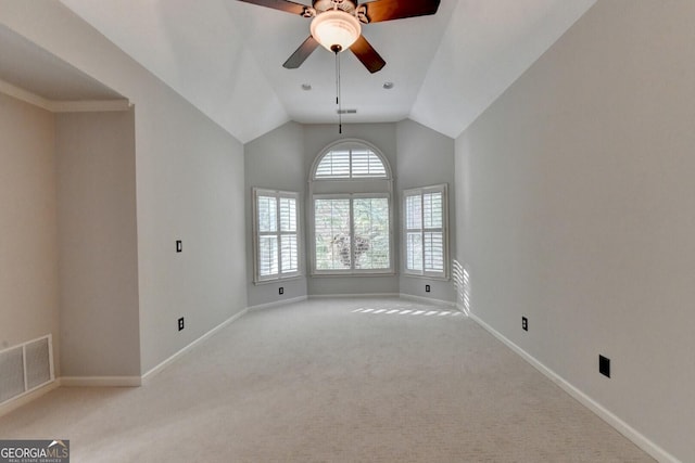 carpeted empty room with ceiling fan and lofted ceiling