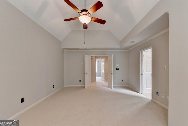 empty room with light colored carpet, ceiling fan, and lofted ceiling