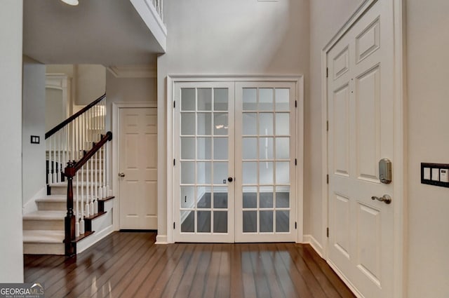 entryway featuring crown molding, french doors, and dark wood-type flooring