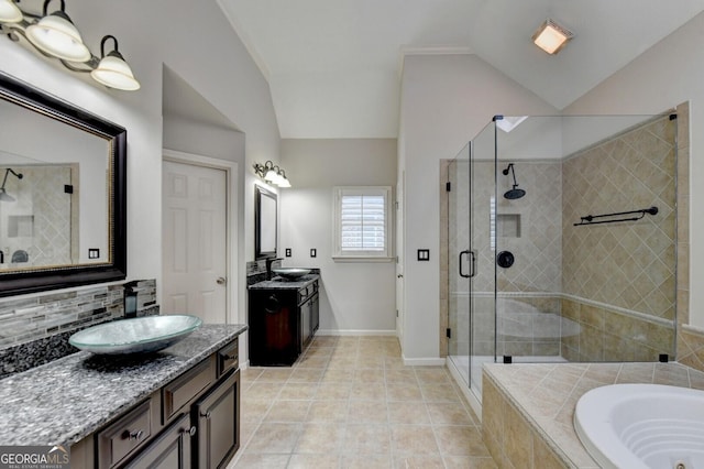 bathroom featuring tile patterned floors, vanity, vaulted ceiling, and shower with separate bathtub