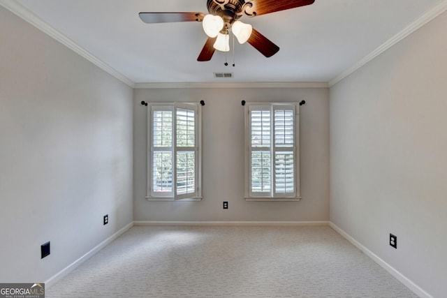 carpeted empty room featuring ceiling fan and ornamental molding