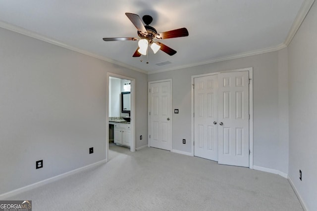 unfurnished bedroom with ensuite bathroom, ceiling fan, light carpet, and ornamental molding