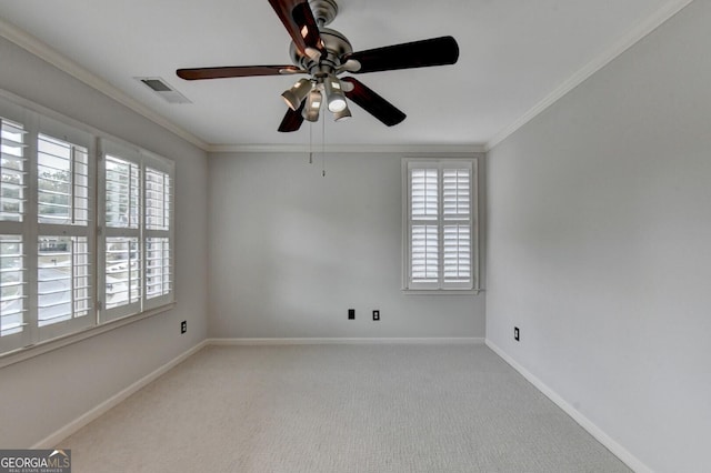 empty room with light colored carpet, plenty of natural light, and ornamental molding