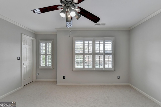 spare room featuring light colored carpet, plenty of natural light, ornamental molding, and ceiling fan