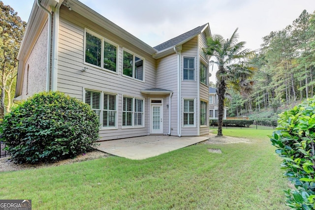 back of house featuring a patio and a lawn