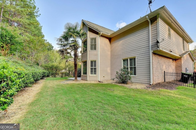 back of house with a lawn