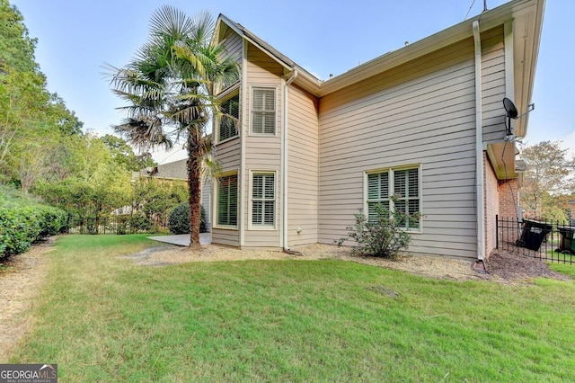 rear view of house featuring a yard