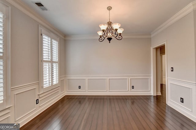 unfurnished room with a notable chandelier, dark hardwood / wood-style floors, and ornamental molding