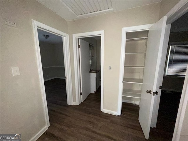 corridor with dark hardwood / wood-style floors