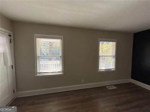 empty room featuring dark hardwood / wood-style flooring