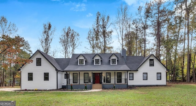 cape cod-style house with covered porch and a front lawn