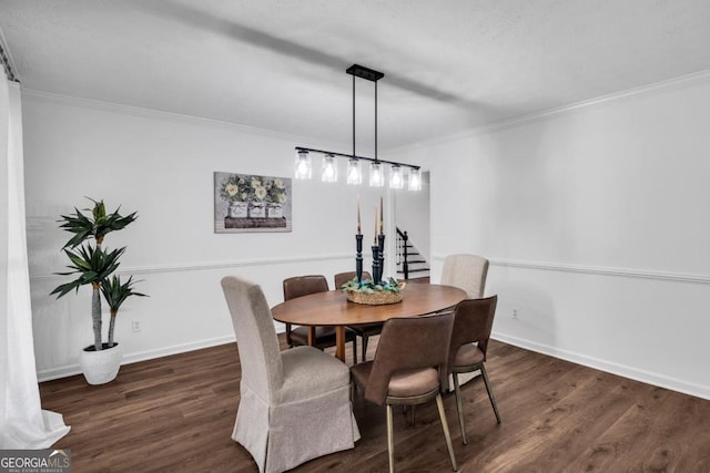 dining space featuring crown molding and dark wood-type flooring