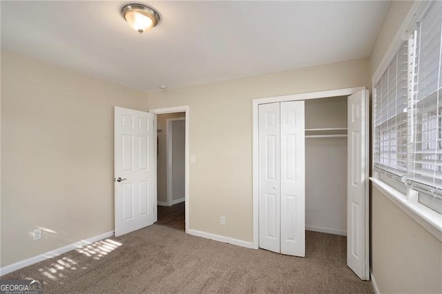 unfurnished bedroom featuring carpet flooring and a closet