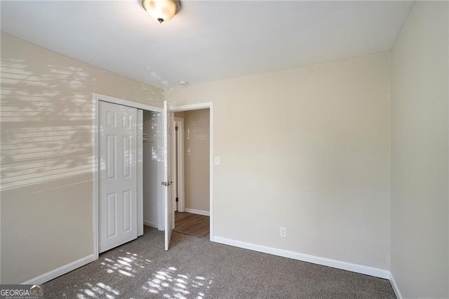 unfurnished bedroom featuring carpet flooring and a closet