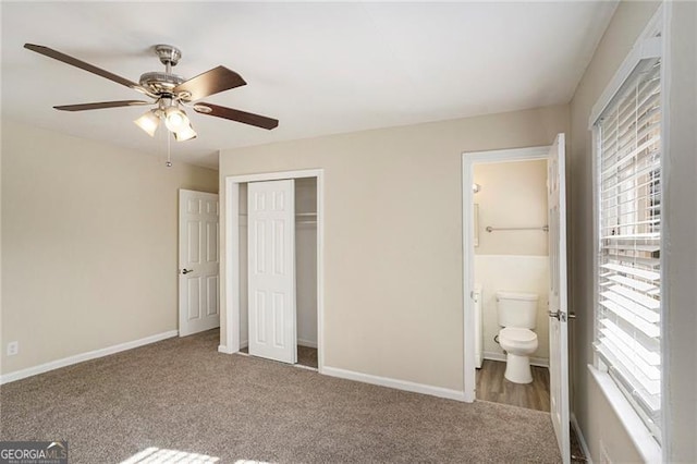 unfurnished bedroom featuring carpet flooring, connected bathroom, ceiling fan, and a closet